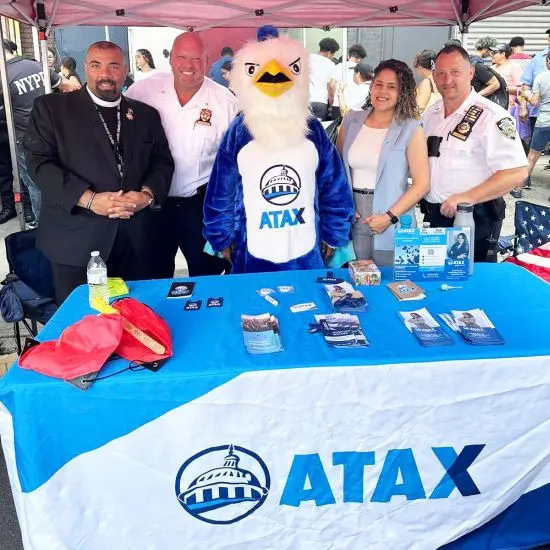 ATAX franchise team at a local community event with the ATAX mascot — neighborhood outreach that powers word-of-mouth referrals